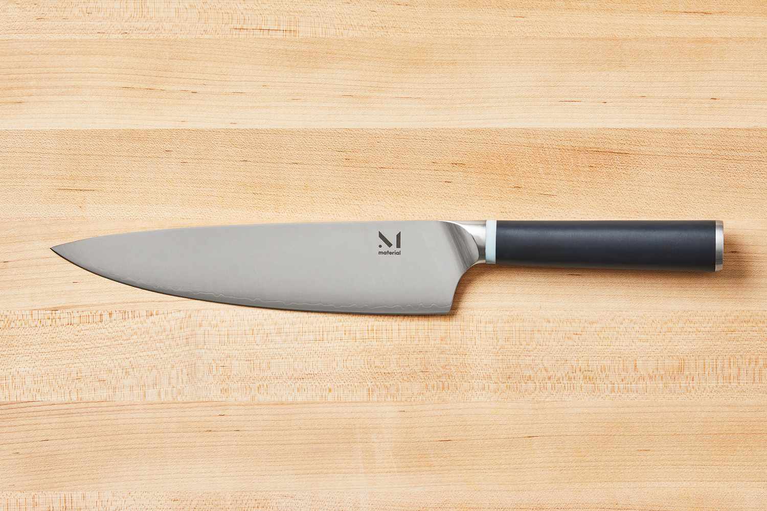 Material The 8-Inch Knife on a wooden cutting board