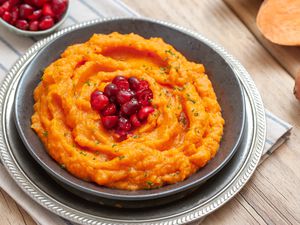 Mashed sweet potatoes with orange juice and cranberries