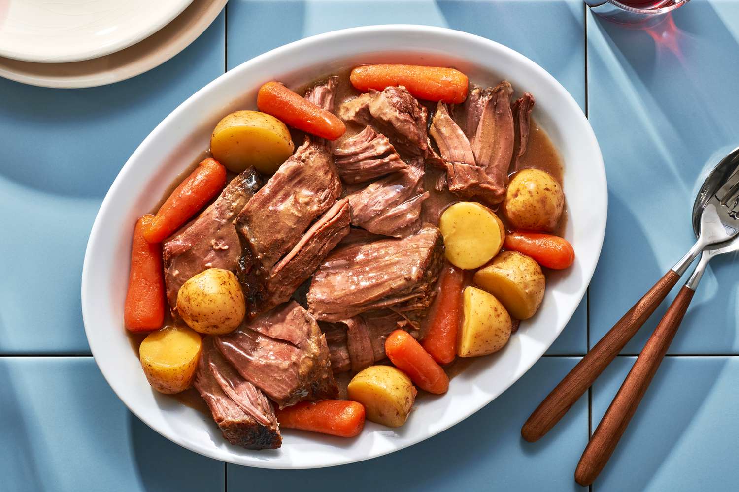 A platter of slow cooker onion soup beef pot roast with potatoes and carrots