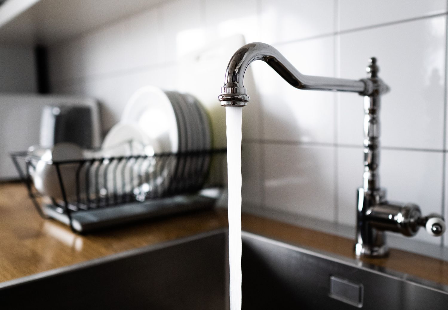 Running tap water in a kitchen sink.