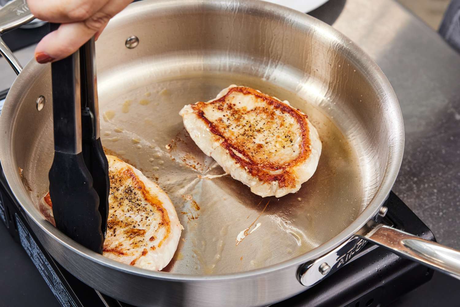 Searing chicken breasts in the All-Clad D5 Stainless Brushed 5-Ply Bonded Cookware Set saute pan