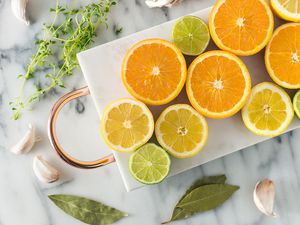 A gathering of citrus fruits cut in half and resting on a platter