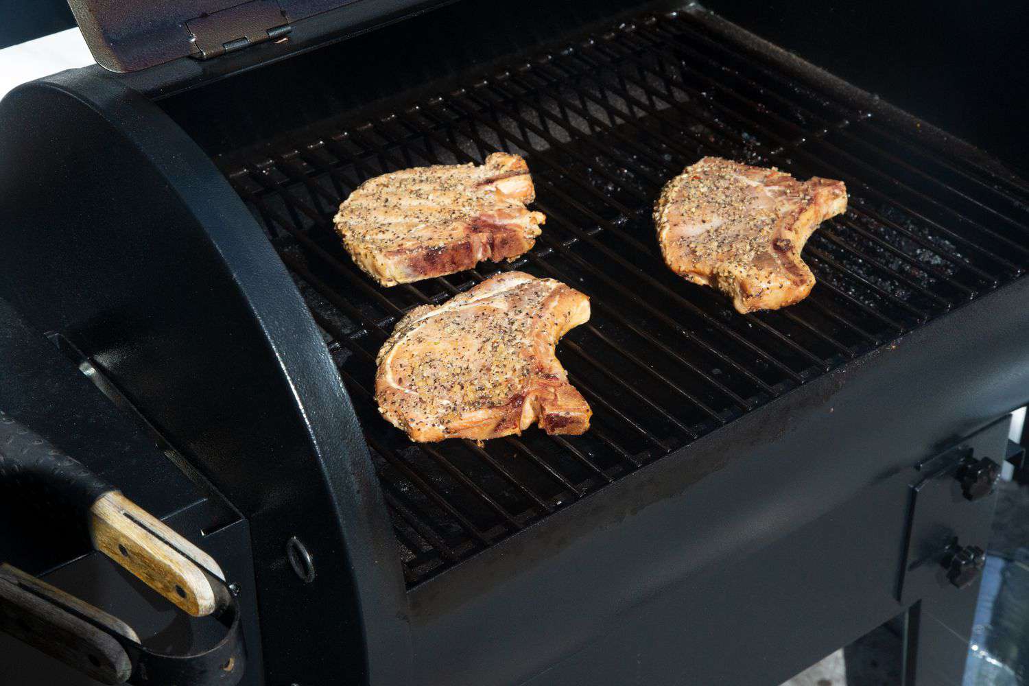 Traeger Tailgater Pellet Grill with pork chops cooking