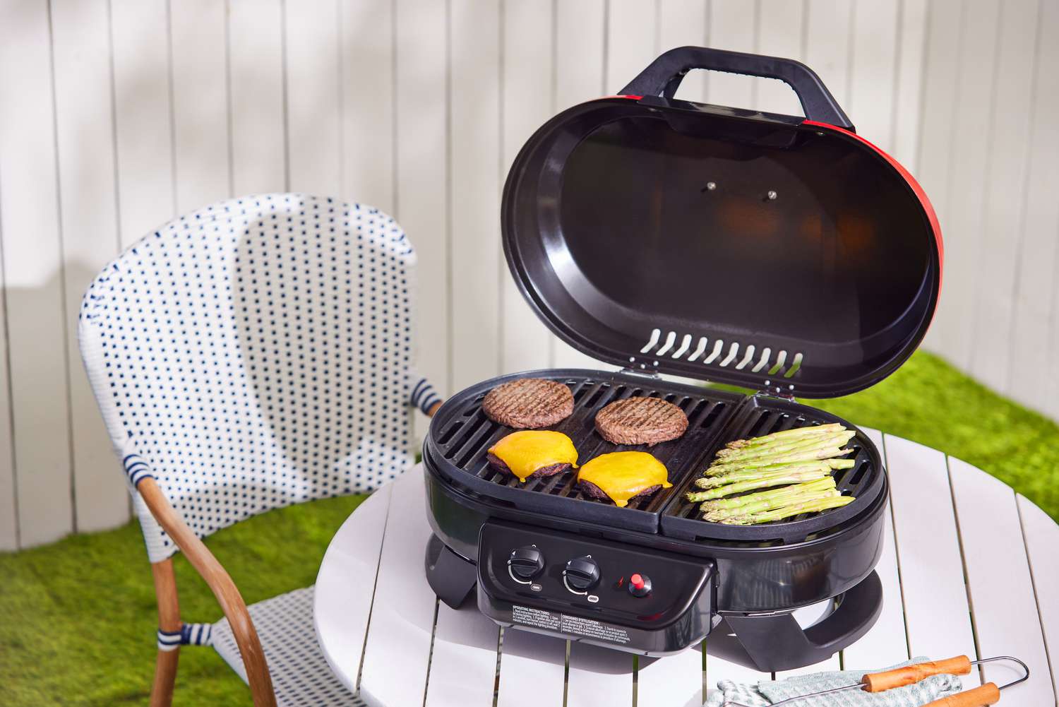 Patties and asparagus grill on a Coleman Roadtrip portable grill