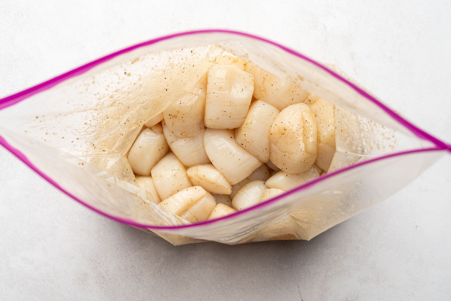 scallops and seasonings in a plastic bag 