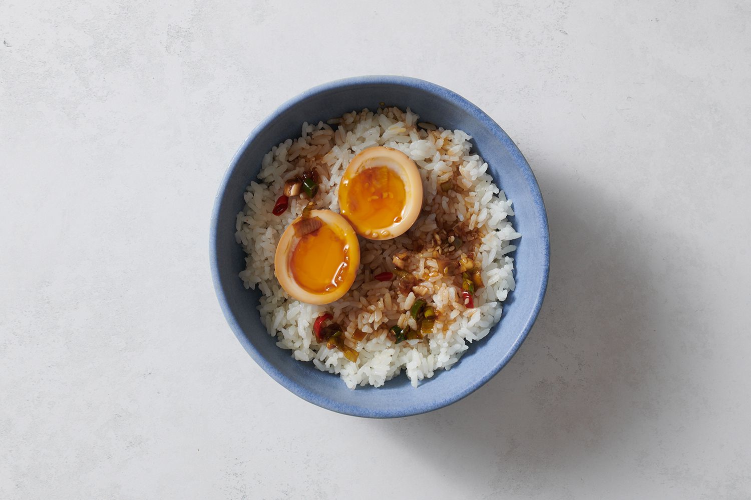 Slices of Mayak Eggs serve in a bowl of rice