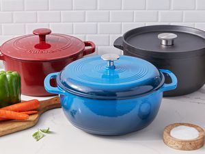 Three Dutch ovens we recommend displayed on a white counter