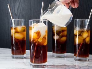 Pouring Cream Over Cold Brew Coffee