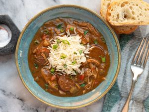 turkey gumbo in a bowl with rice and french bread