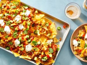Easy Loaded Nachos on a baking pan and on a plate 