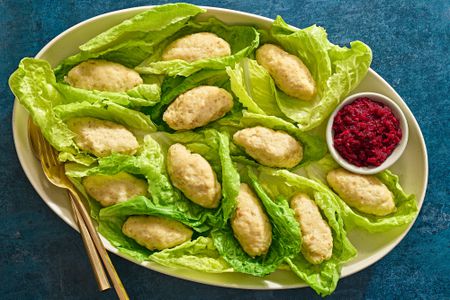 A large platter of gefilte fish served on lettuce and served with beet relish