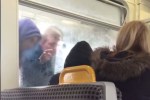 The furious man hurls abuse at a man in a hooded top on the metro