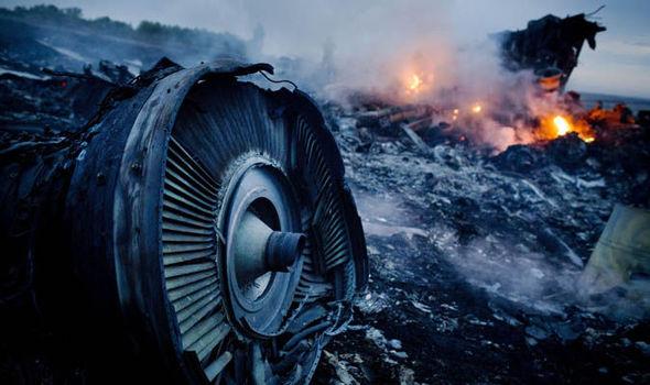  Debris from Malaysia Airlines Flight 17 is shown smouldering in a field