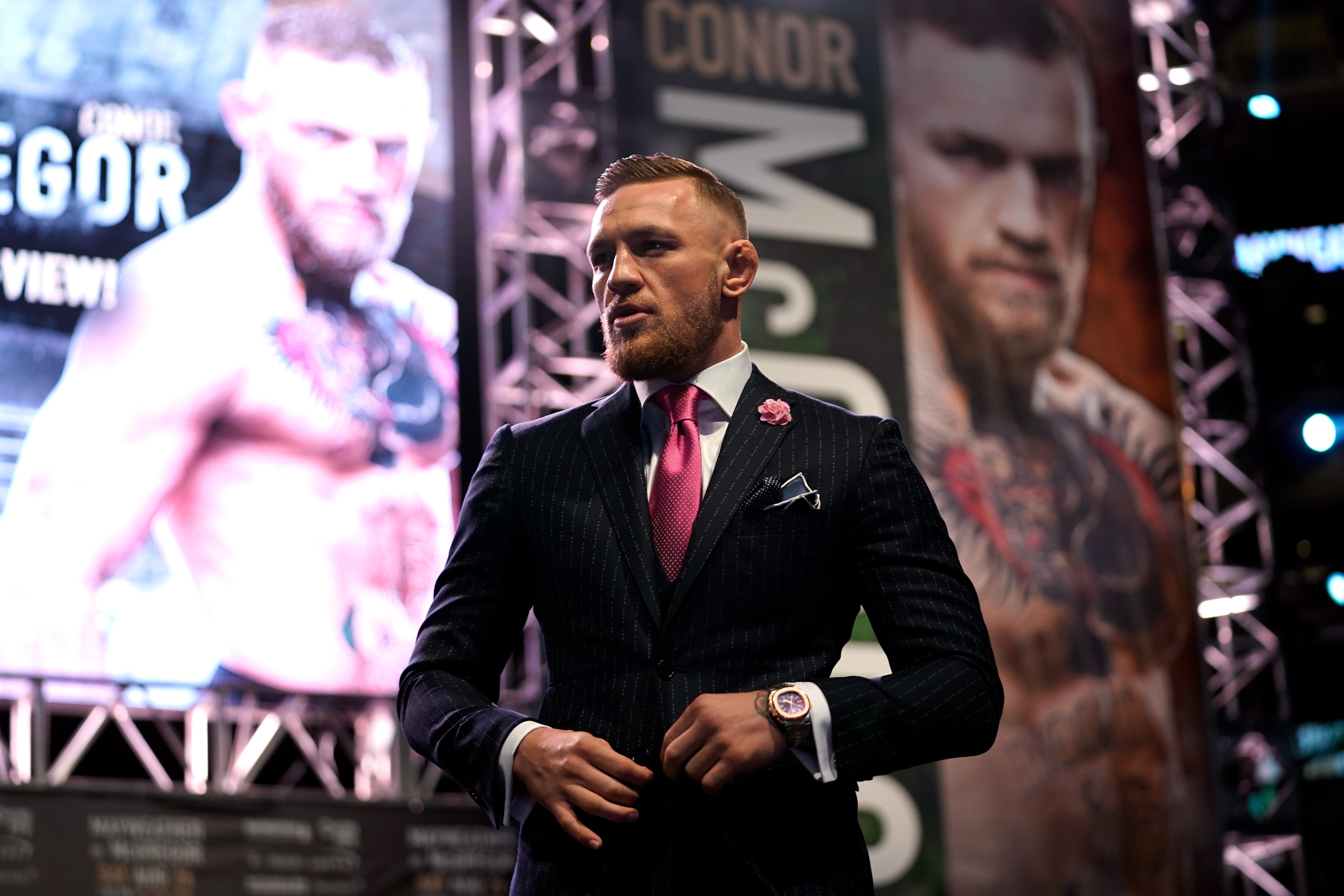  Paired with a smart suit, McGregor looks the business with his £81k watch