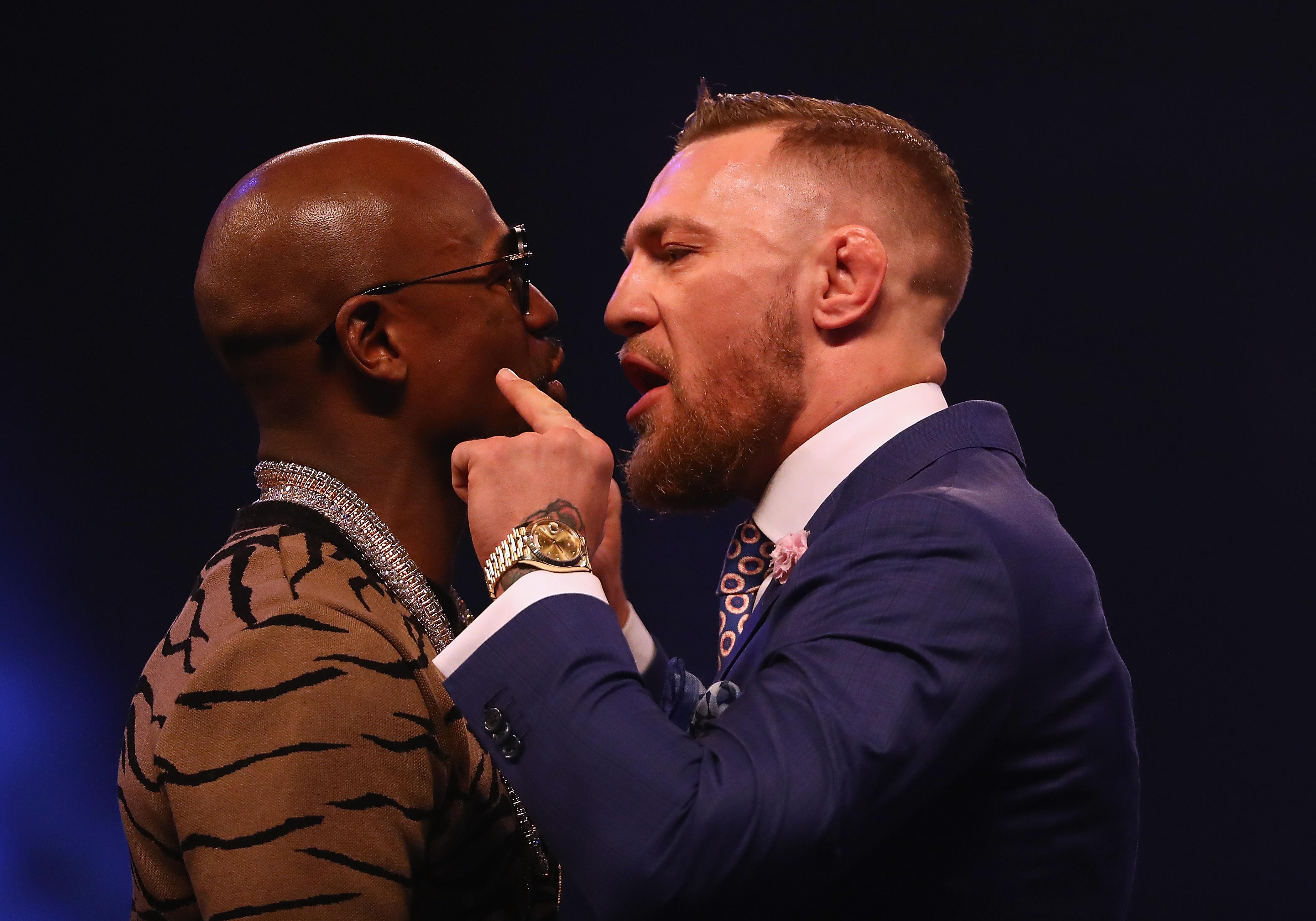  McGregor flashes his Rolex Day-Date 40 Gold in a heated exchange with Floyd Mayweather