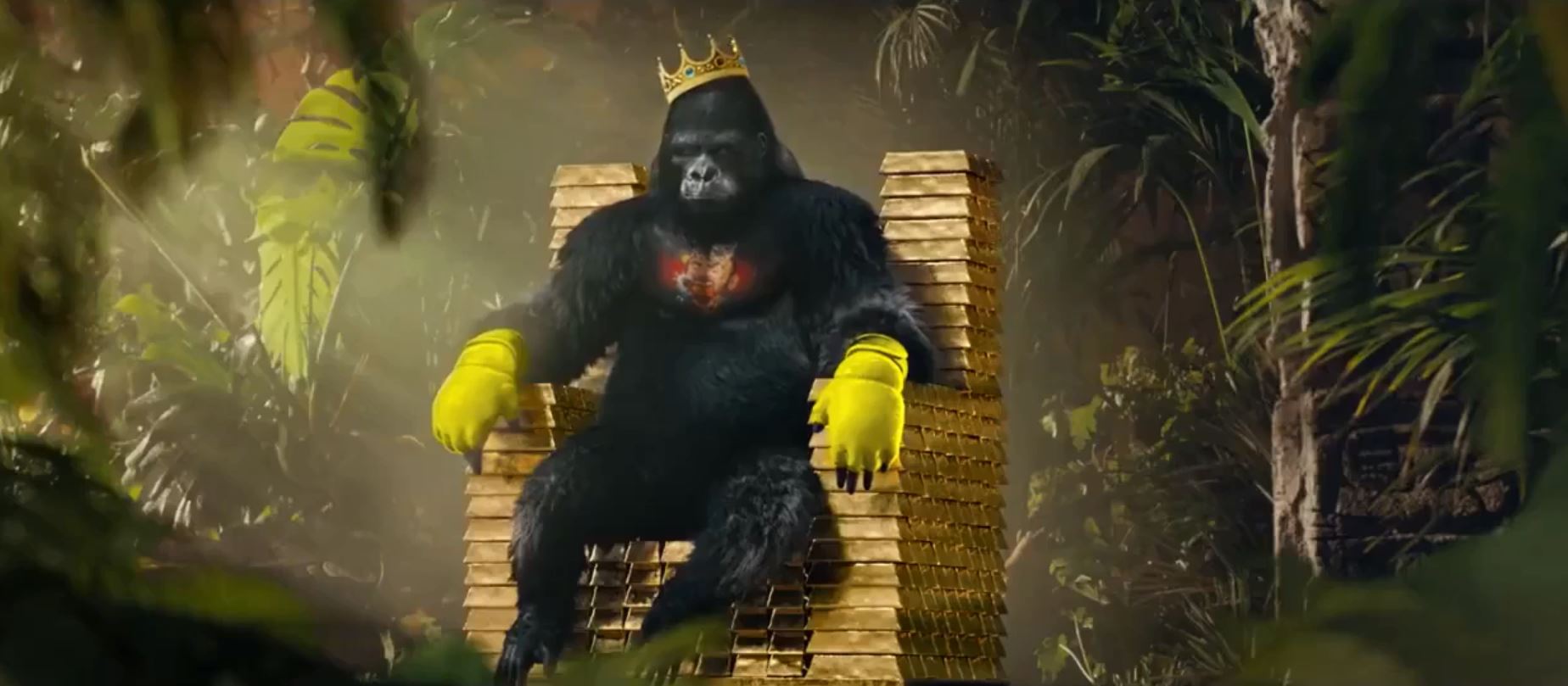  A gorilla with a crown on its head sits on a throne - with McGregor's yellow gloves on