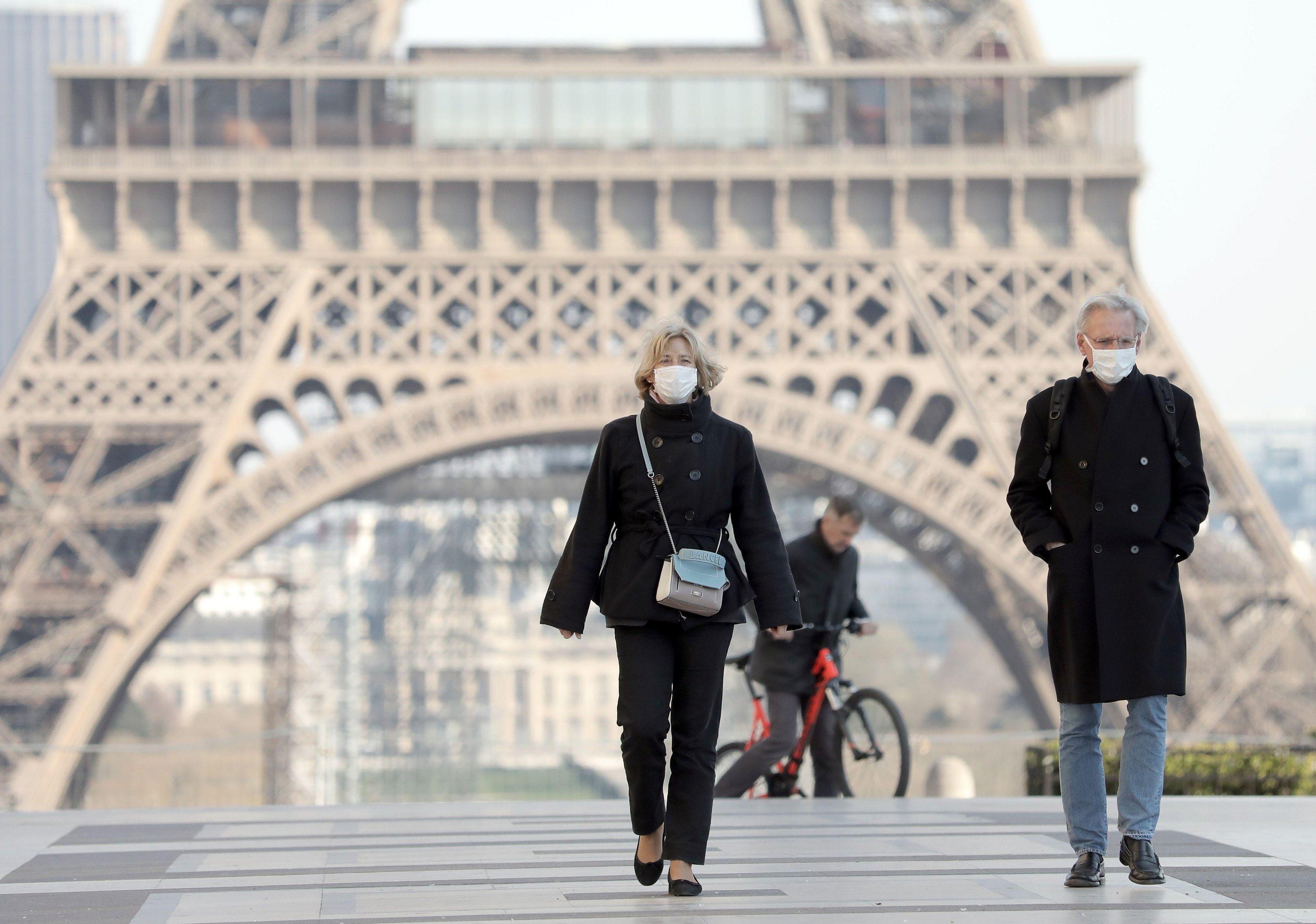  Parisians walk in front of the Eiffel Tower last month before the ban