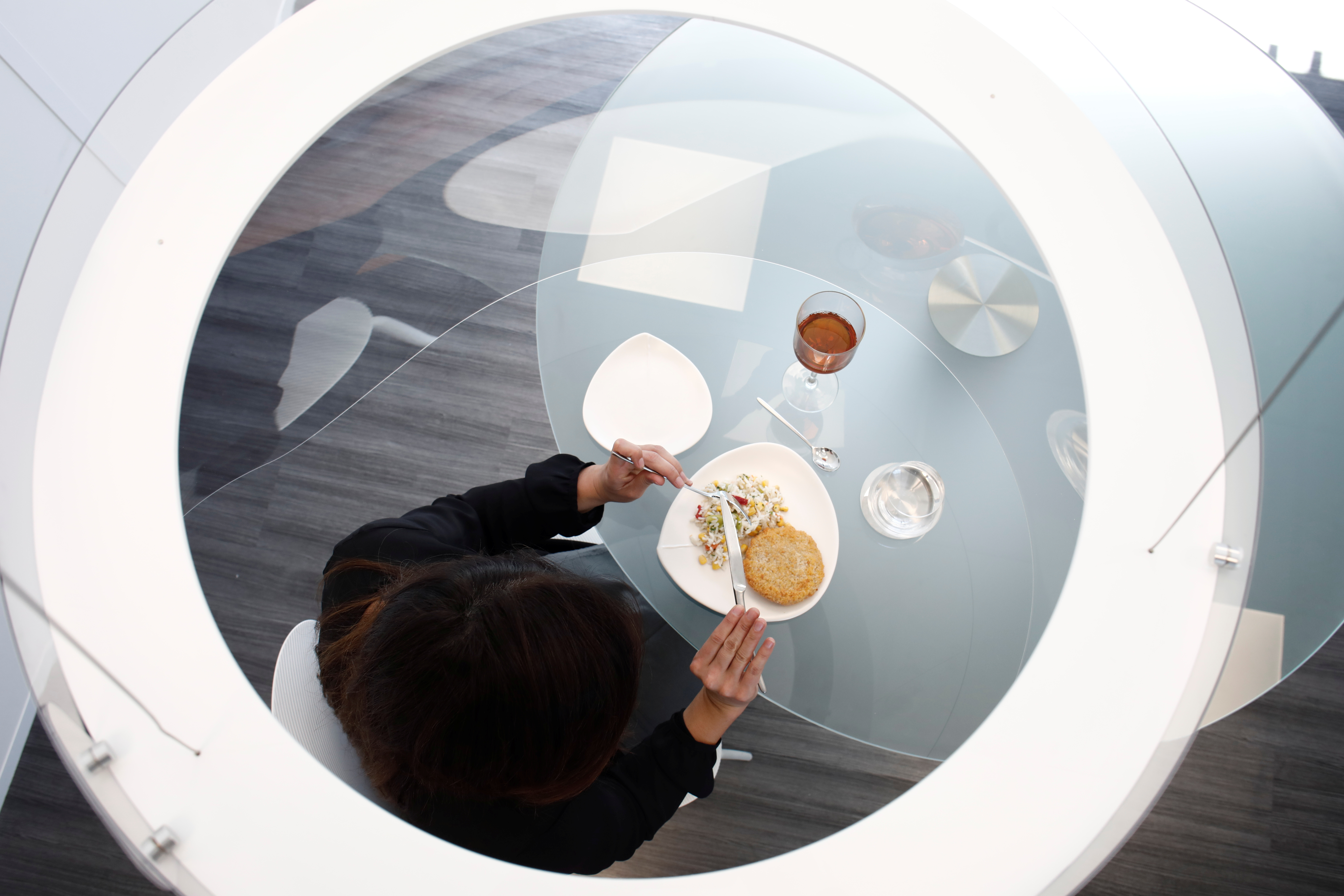  A diner eats her meal in safety within the plexiglas bubble