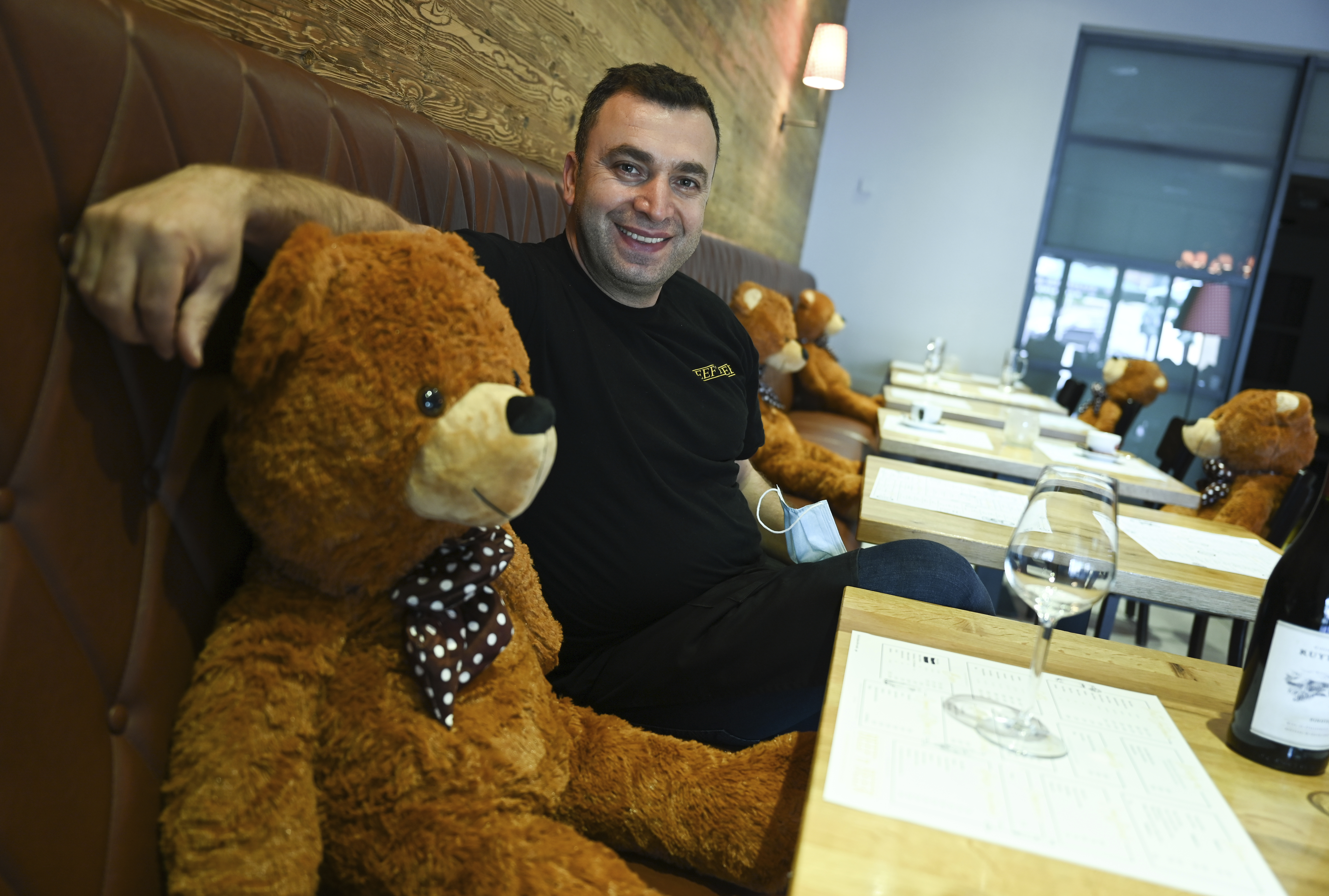  manager Musa Gezer sits in his restaurant "Beef'n Beer" next to a big teddy bear in Hofheim, Germany