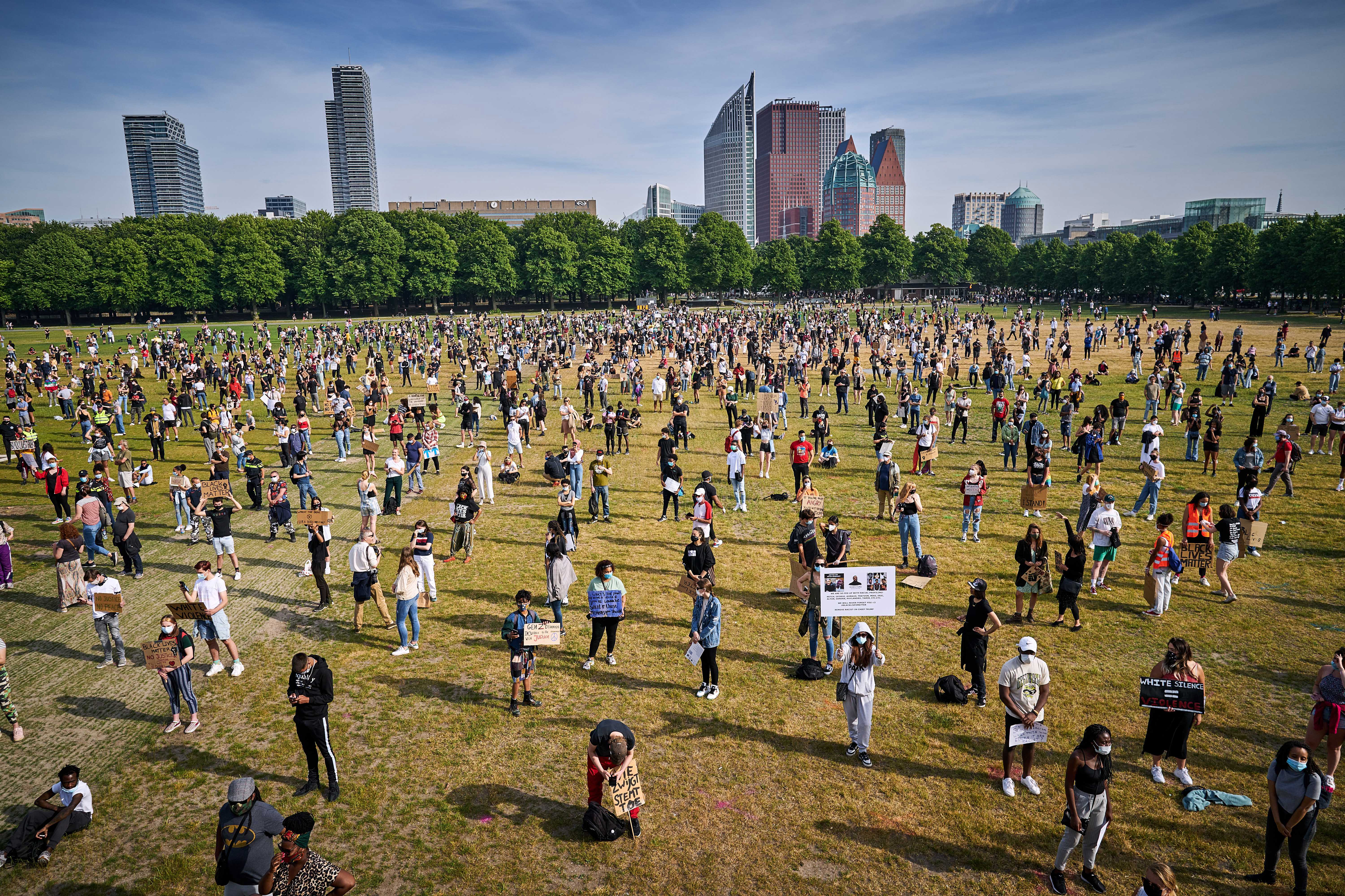  Protesters stand at a safe distance apart during a protest on the Malieveld in The Hague, The Netherlands