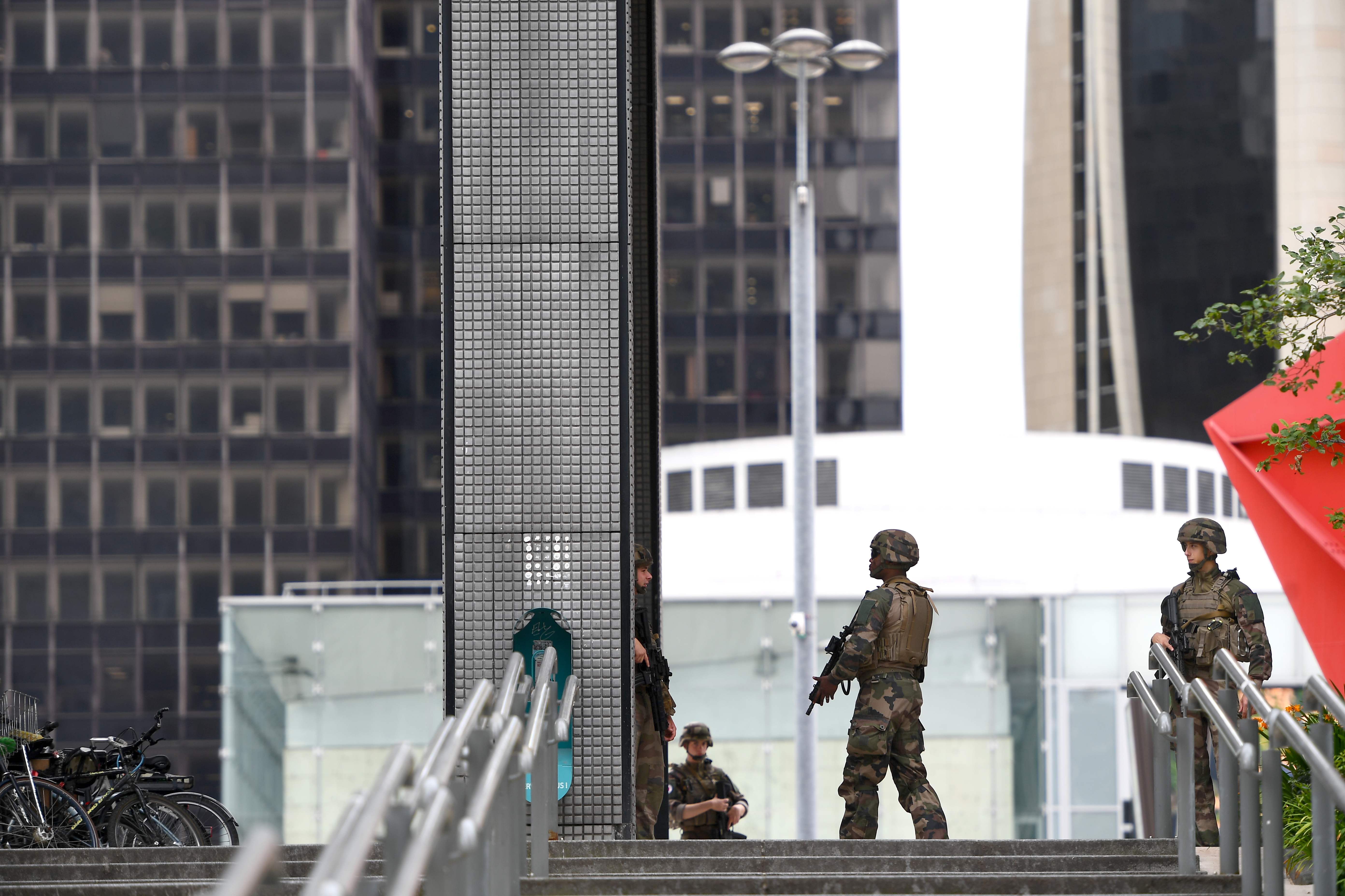 Armed servicemen patrol outside the centre