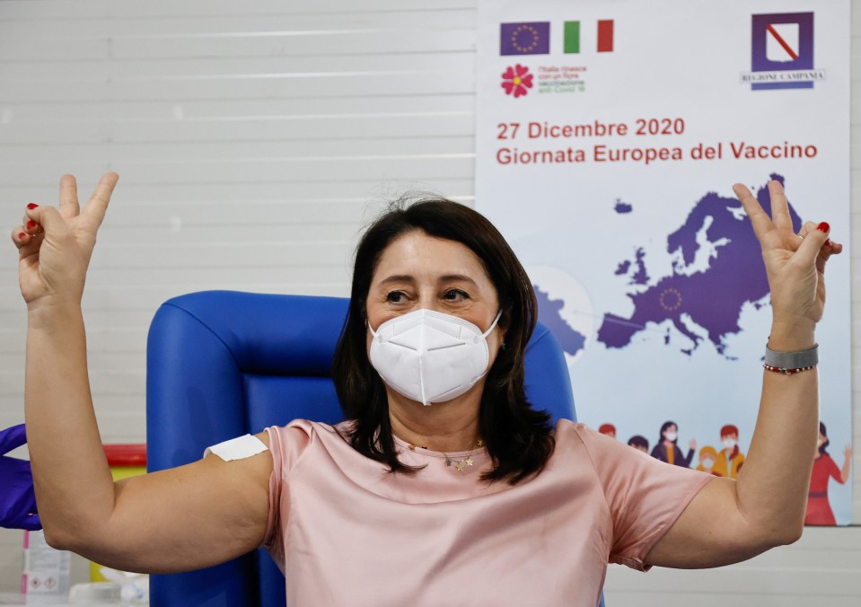 Doctor Filomena Licciardi gestures after receiving the jab at the Cardarelli hospital in Naples, Italy