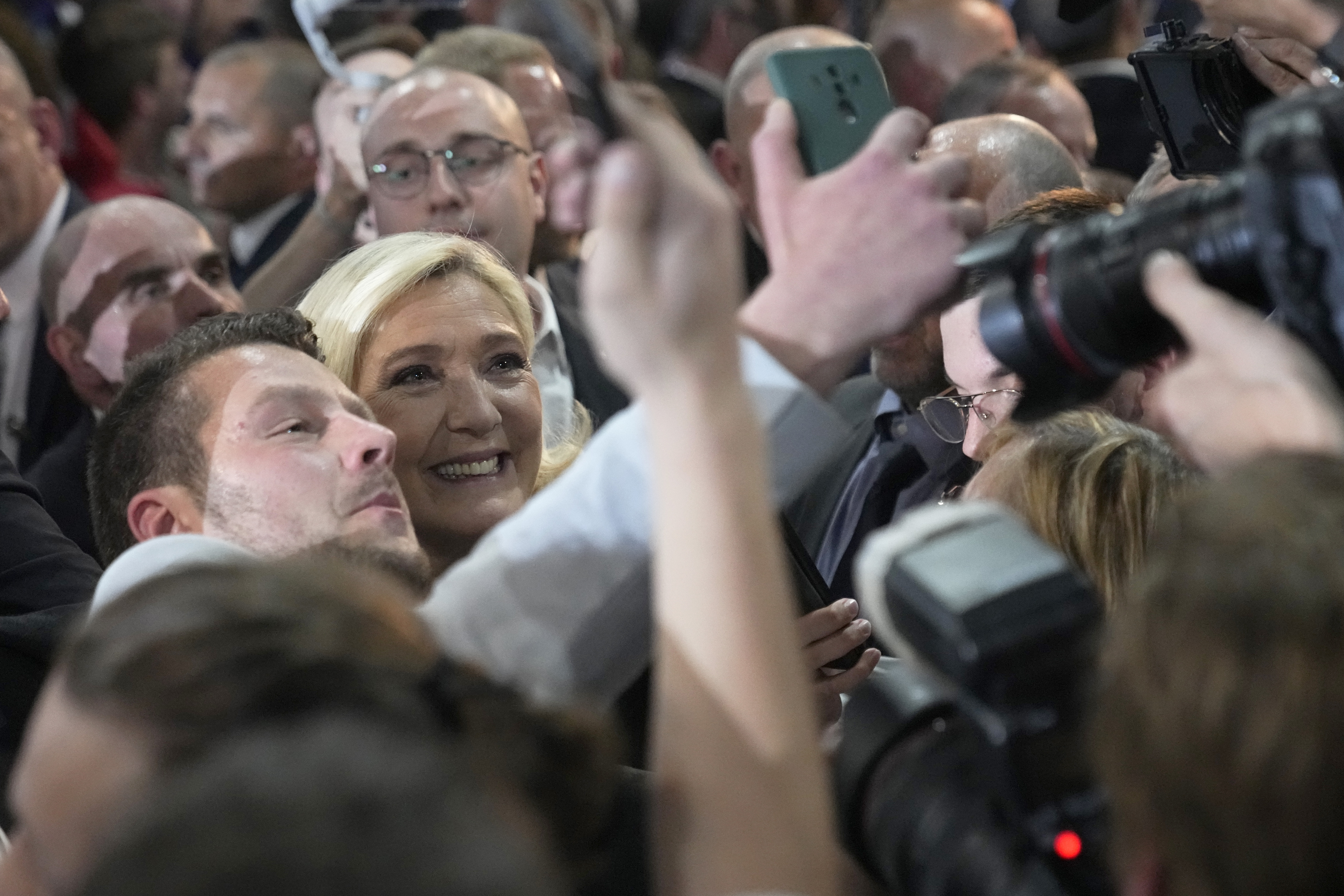 Le Pen poses with supporters at a rally earlier this week