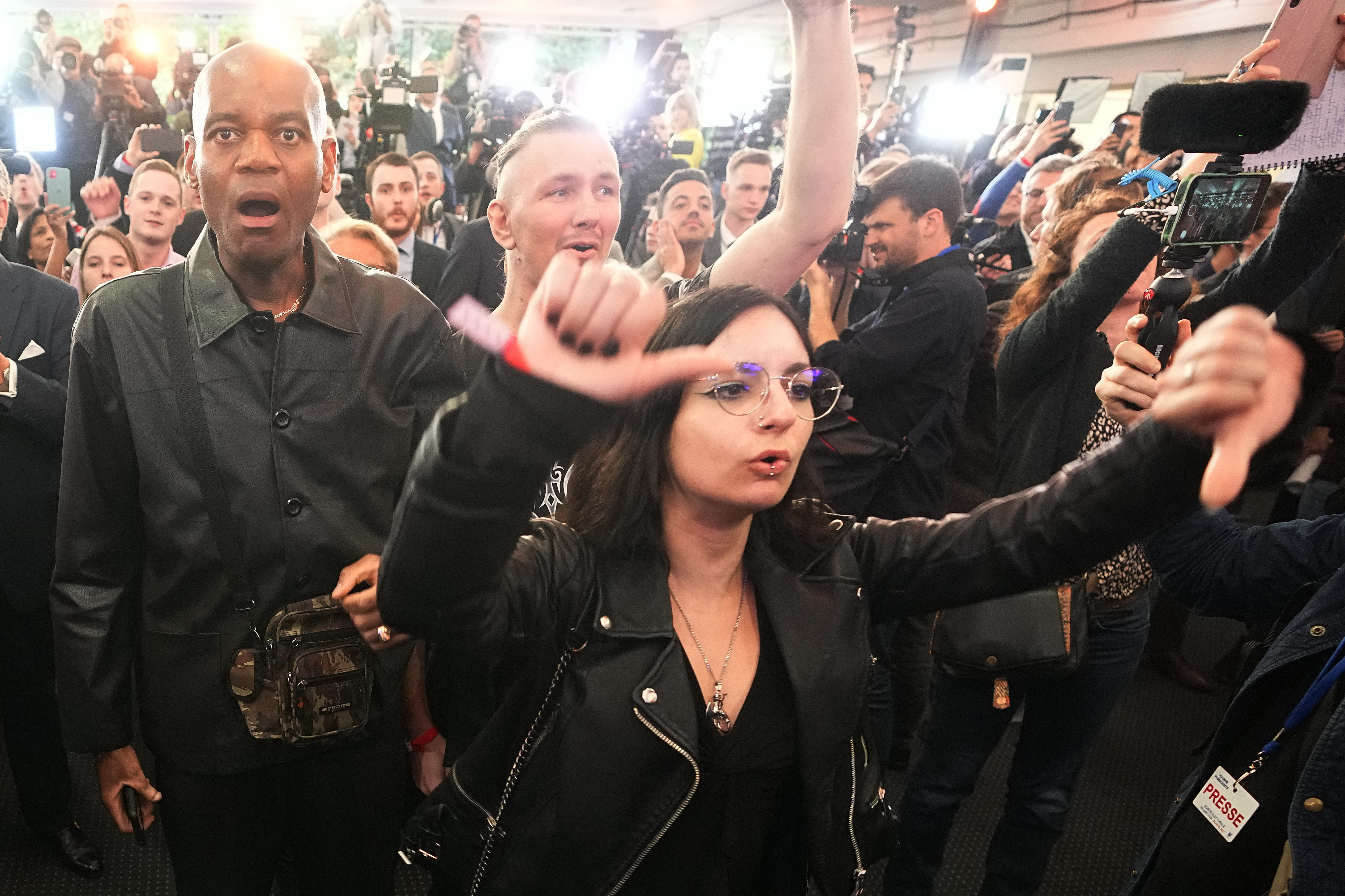 Supporters of far-right leader Marine Le Pen react as they heard the early result projections