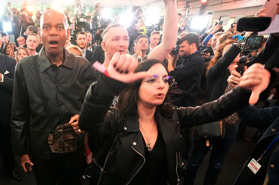 Supporters of far-right leader Marine Le Pen react as they heard the early result projections