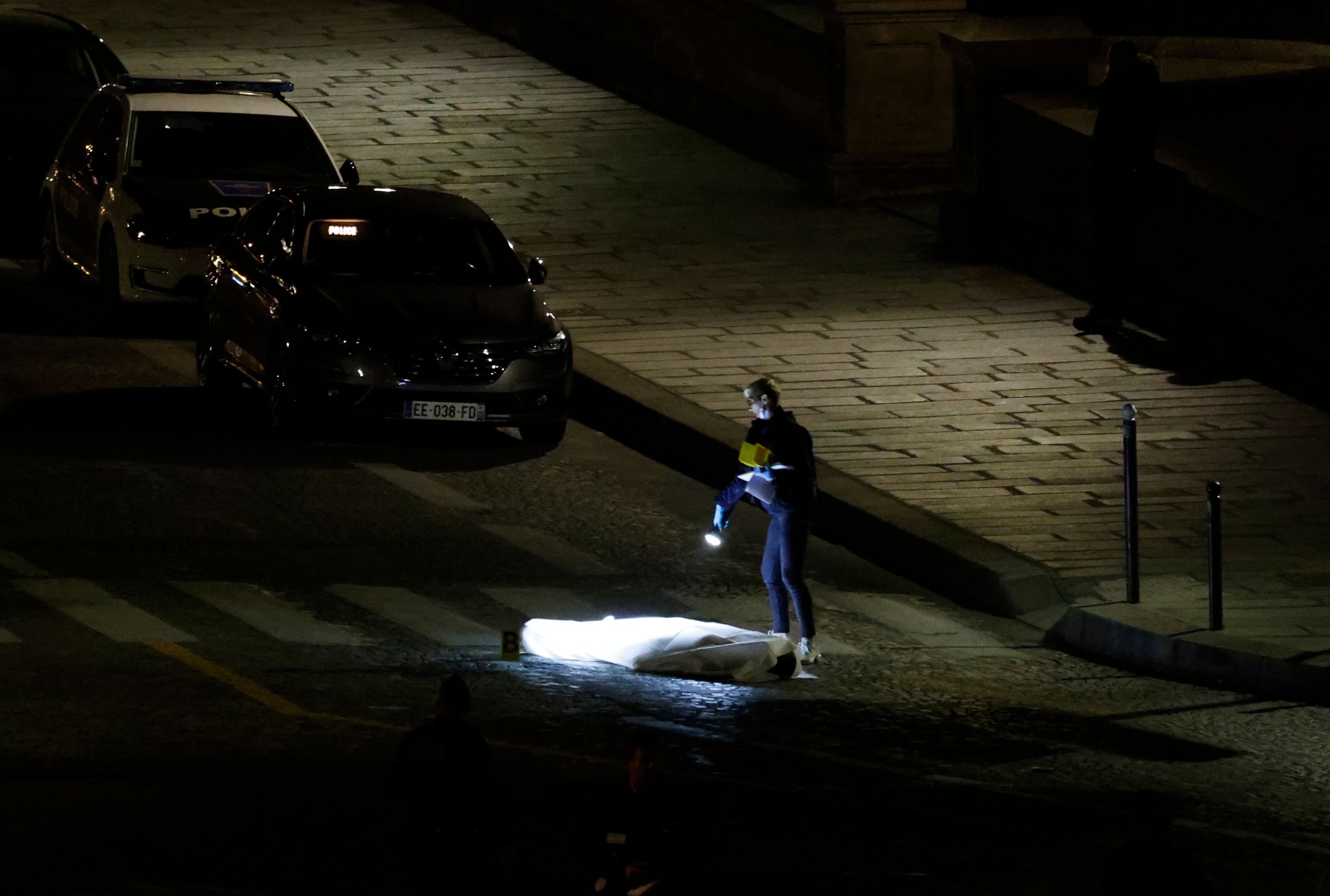 An officer was pictured looking over the body of one passengers