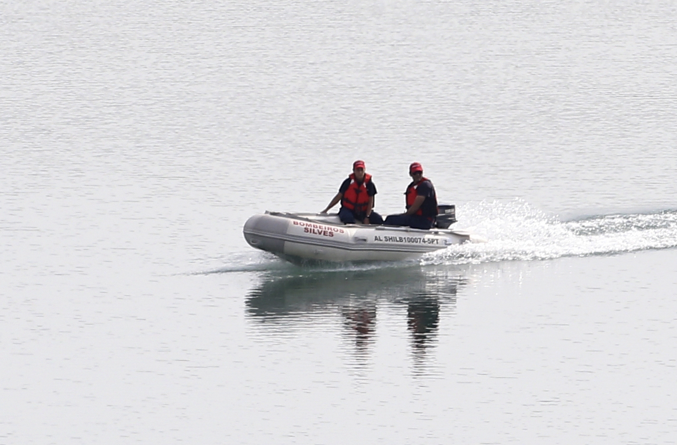 Search teams launched a boat onto the water