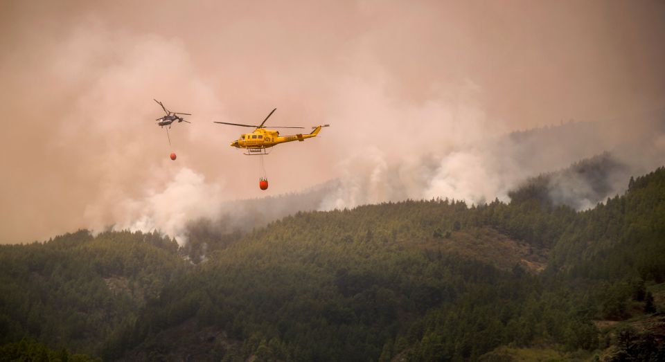 Helicopters have been drafted in to drop water over a huge wildfire