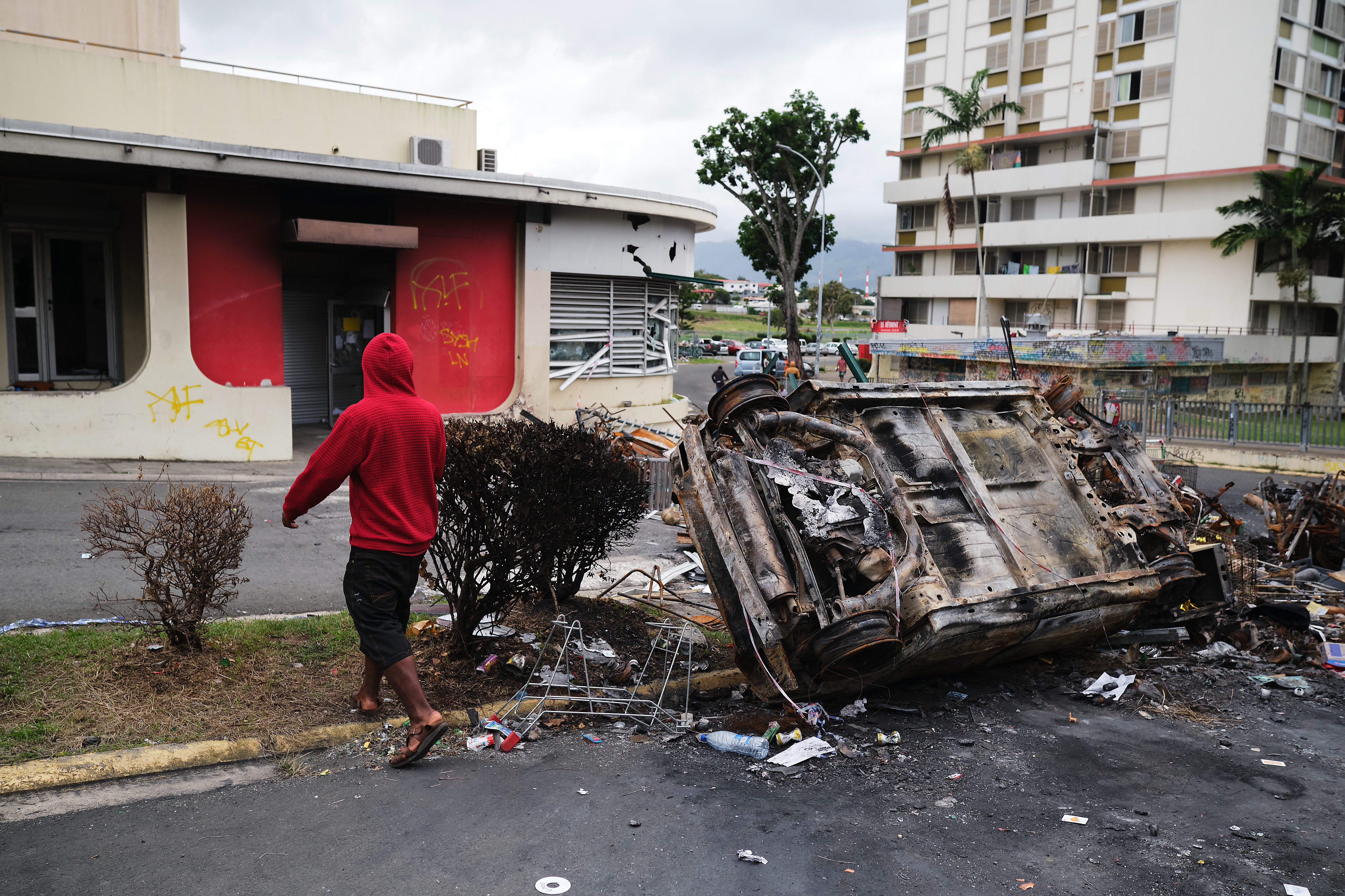 Burnt-out vehicles lay strewn across roads in Noumea's Magenta Tour district