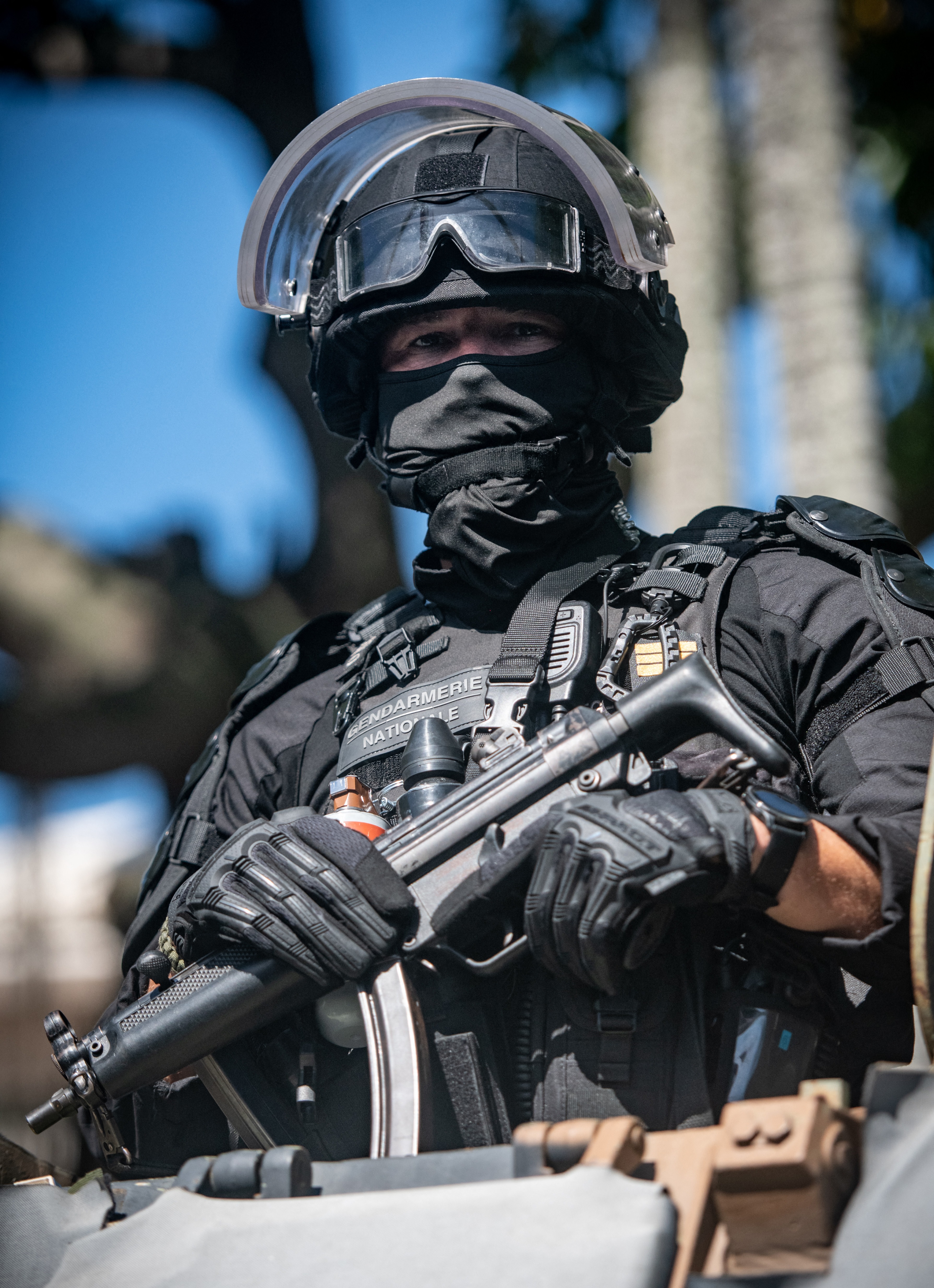 A Gendarmerie officer looks on from an armoured vehicle