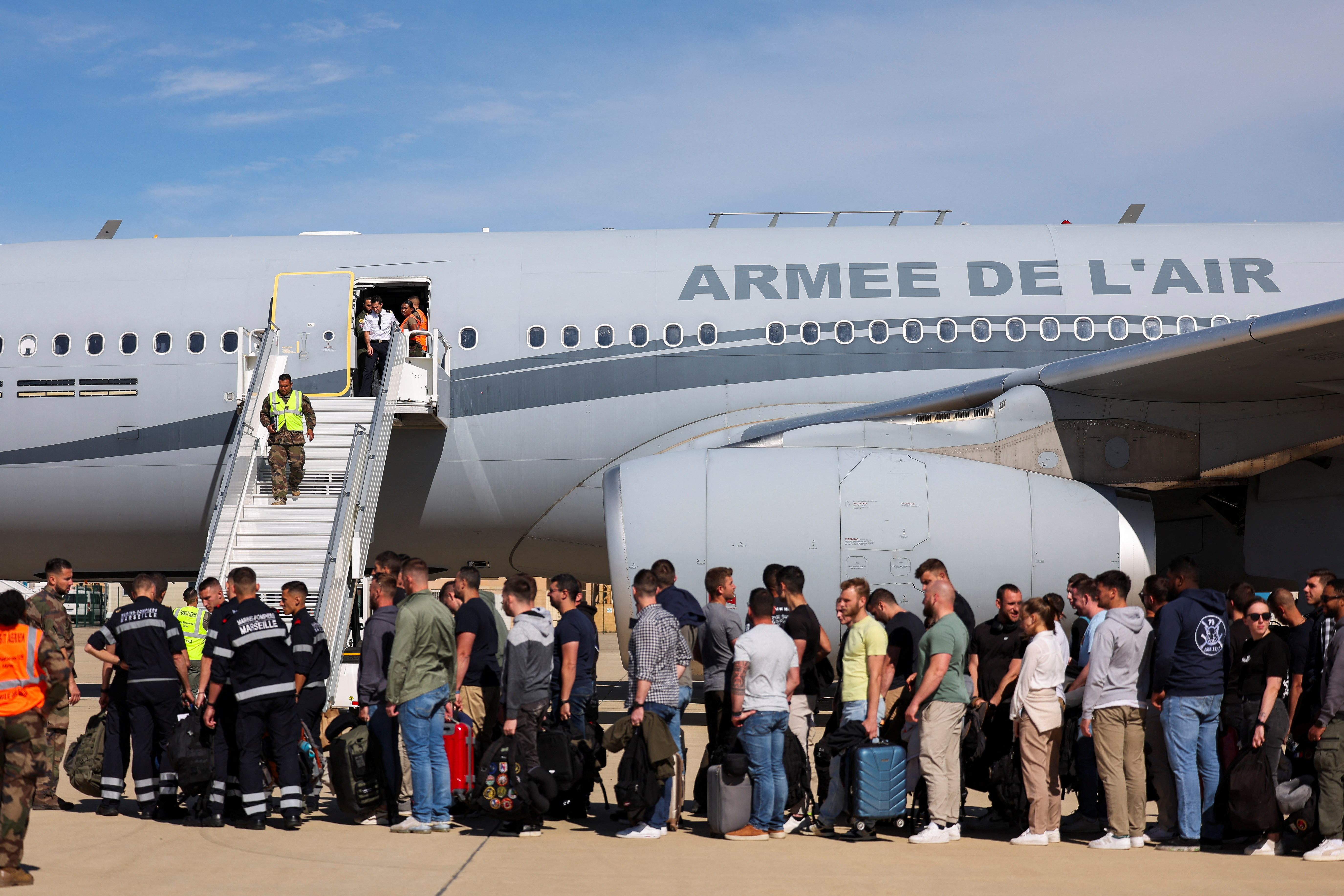 Passengers board a plane of the French Air Force at Istres military airbase