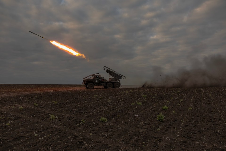 Ukrainian servicemen fire a BM-21 ‘Grad’ multiple rocket launcher at Russian positions