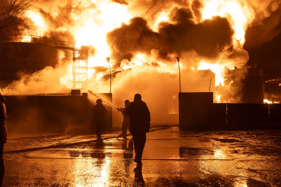 Firefighters try to extinguish flames raise after a gas station was hit by the Russian drones in Kharkiv, Ukraine