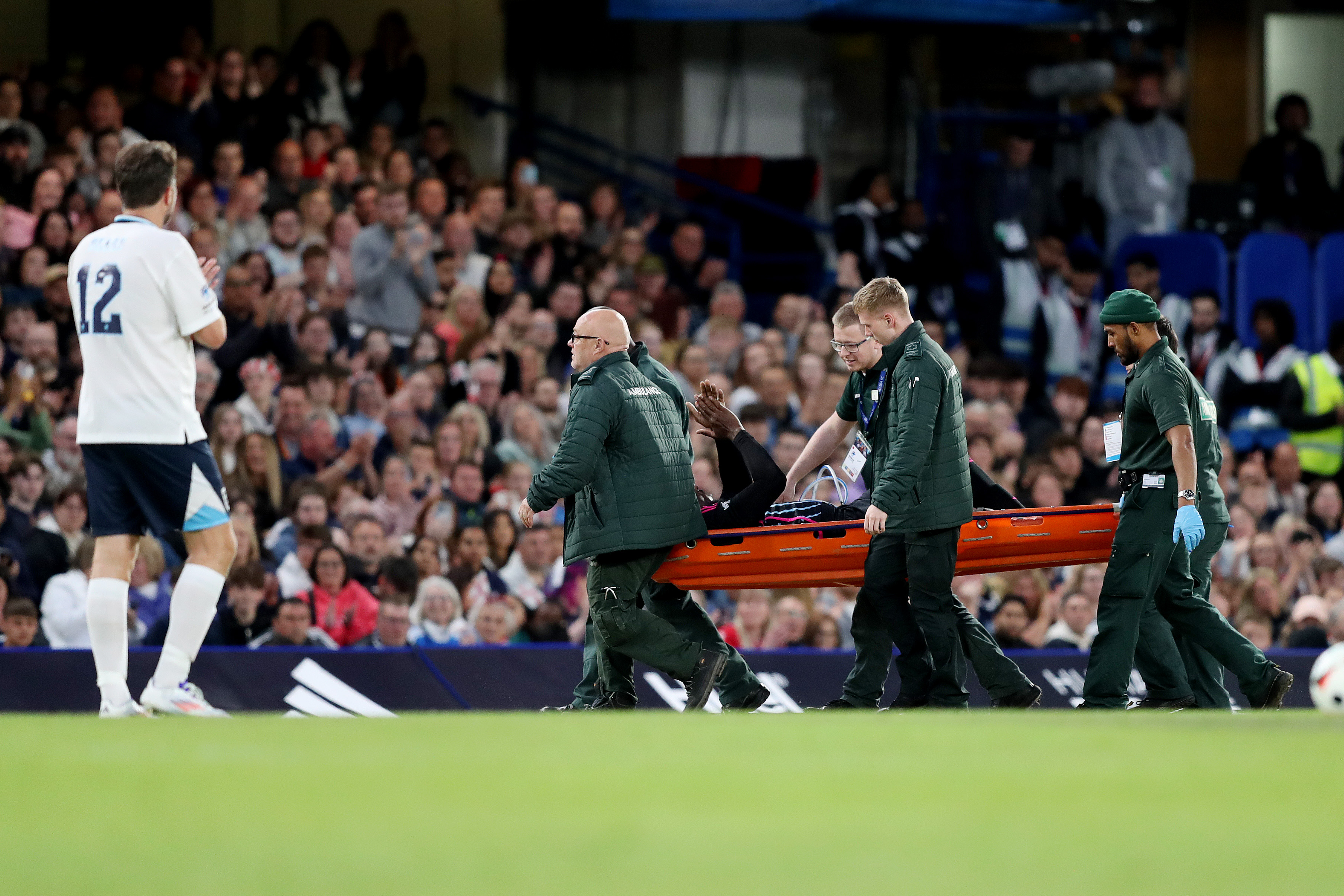 The Olympic superstar was stretchered off the pitch at Stamford Bridge