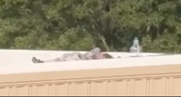 The shooter - Thomas Matthew Crooks - on a roof at the rally