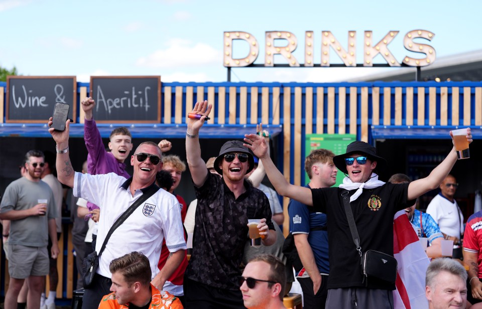 England fans enjoy a drink at the Reichstag Euro 2024 Fan Zone in Berlin, Germany