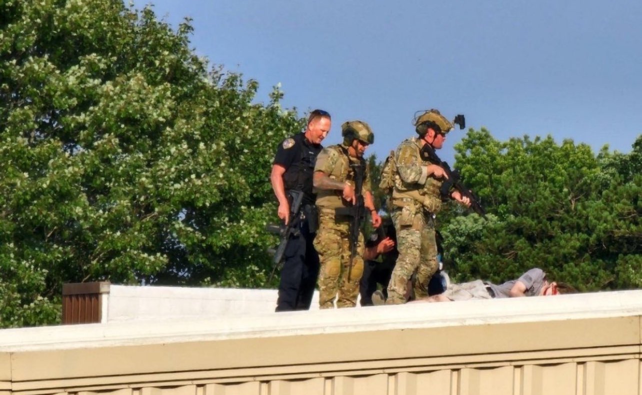 Police surround the body of Thomas Matthew Crooks on a roof