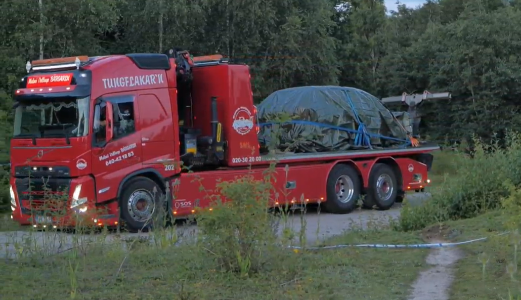 A truck removes the car from the industrial estate