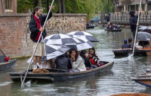 a group of people in a boat with umbrellas that say carlsberg