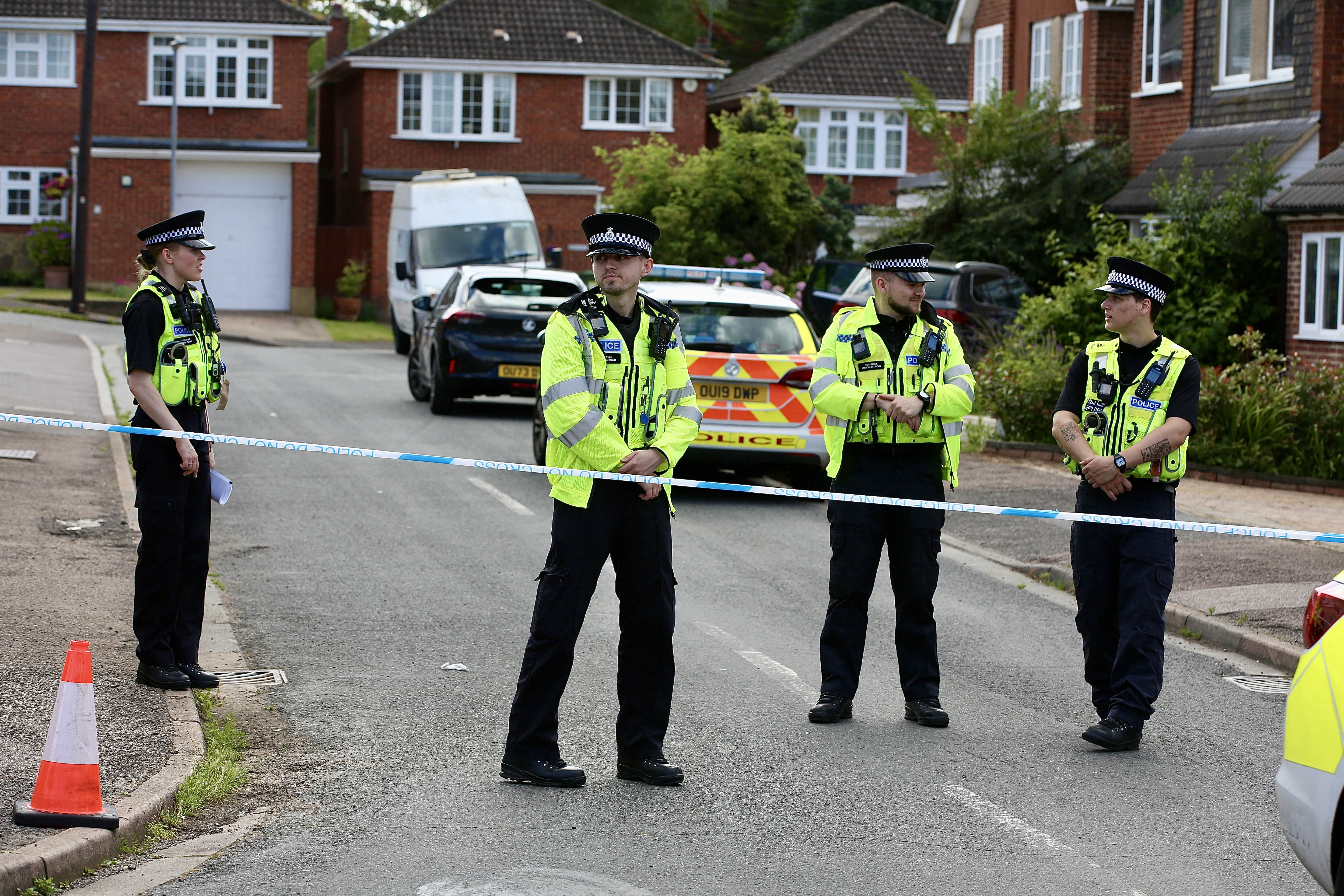 Police at the scene following the deaths of the BBC's John Hunt's wife and daughters