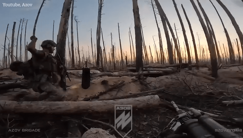 A Ukrainian soldier launches a grenade into the next trench