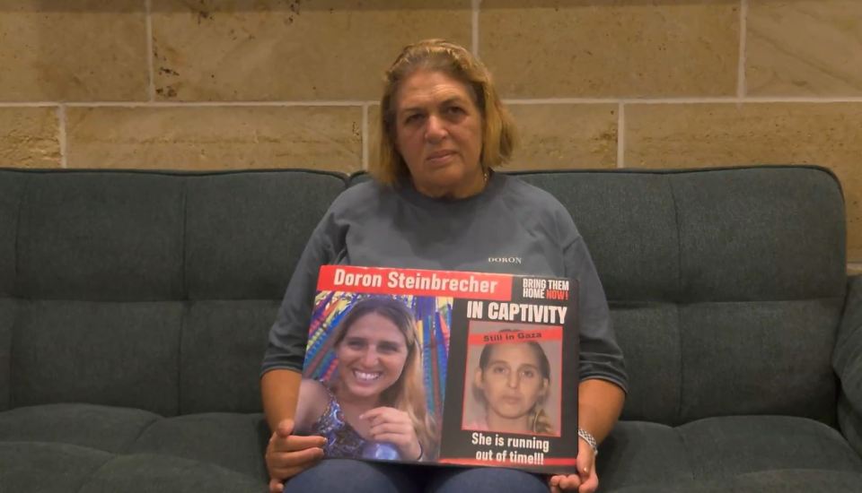 Simona Steinbrecher, 63, speaking to The Sun with a picture of her daughter Doron in hand