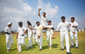 This stock photo depicts a group of people celebrating their victory in a cricket match. The team is shown lifting the batsman on their shoulders as a sign of their triumph. The players are dressed in cricket uniforms and displaying a great deal of joy and excitement. The video captures the camaraderie and unity among the team members in their moment of success.