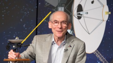 Stone holding a model of a spacecraft. The Voyager 1 and 2 probes were, as Stone put it, “Earth’s ambassadors to the stars”