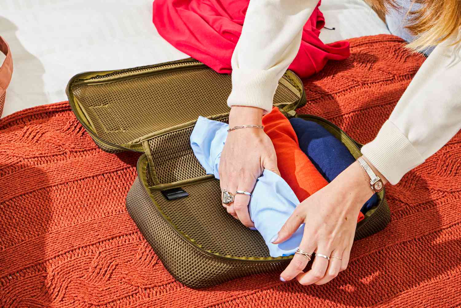 A person packing the Dagne Dover Roma Packing Cubes