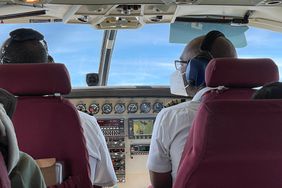 The pilot, co-pilot and passengers must wear face masks on planes, including this one, a privately chartered East African bush plane.